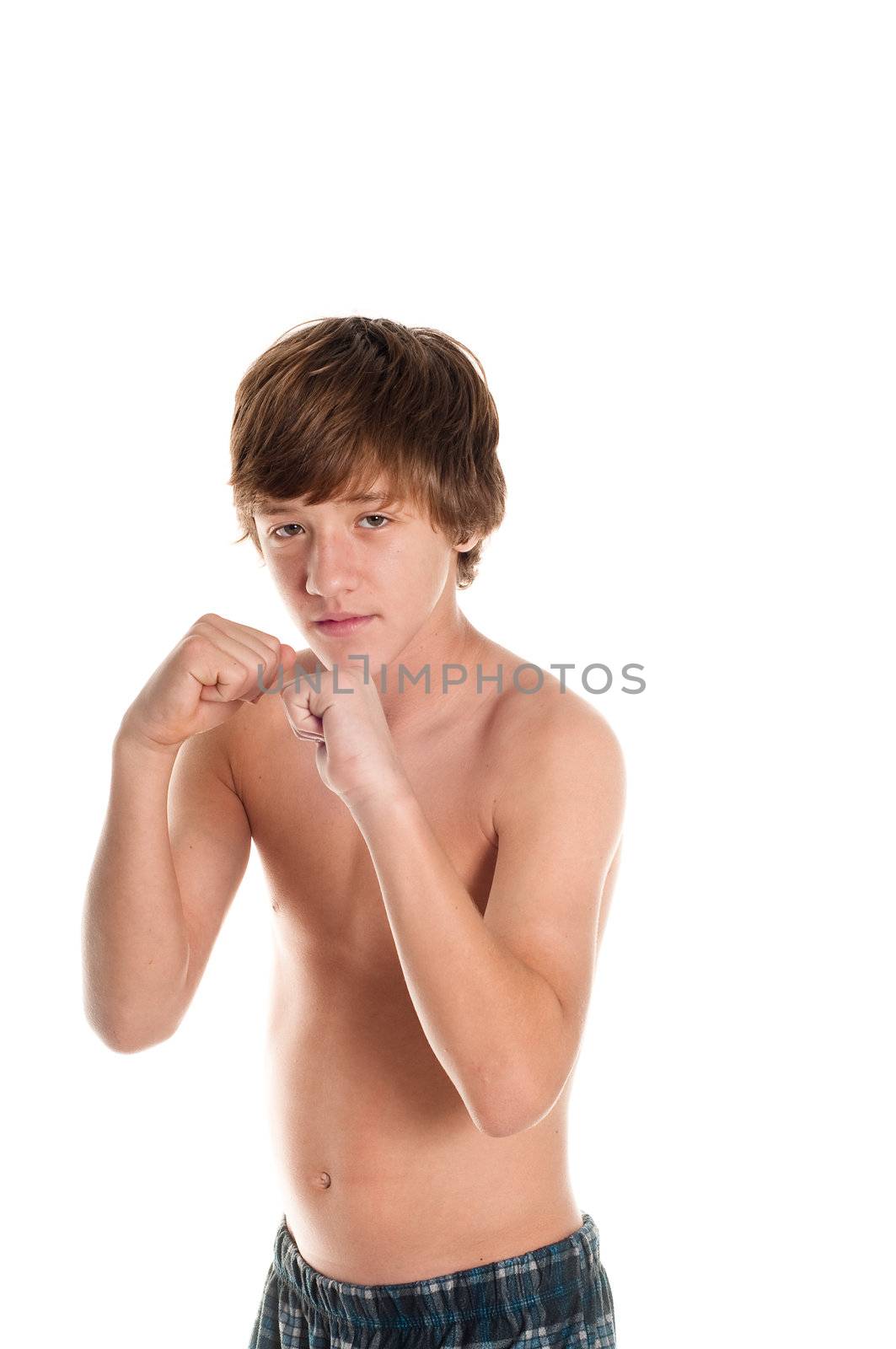 Young teen boy in boxing stance with serious face. Isolated on white.