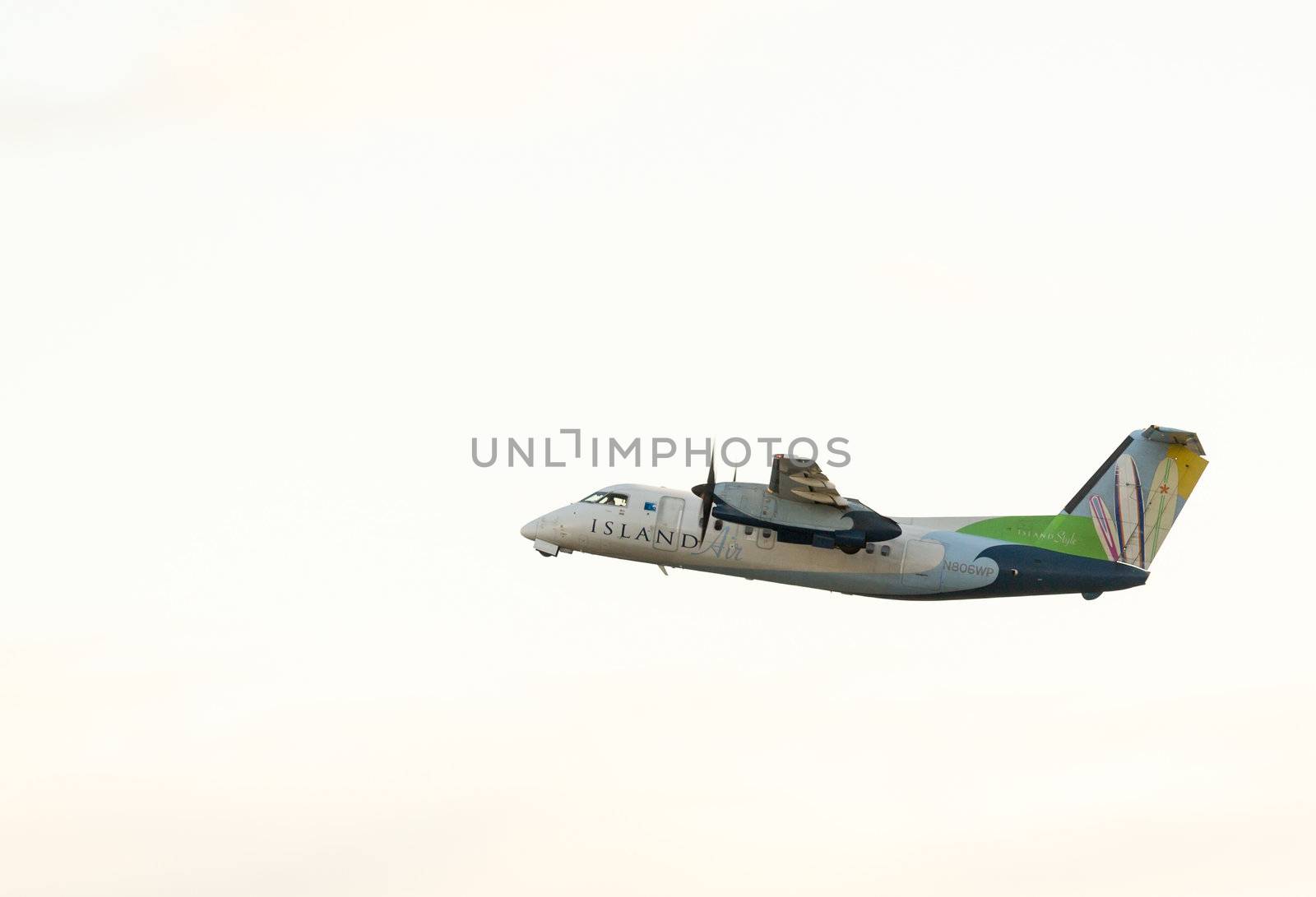 Honolulu, HI - 23 JANUARY: Island Air Dash 8 taking off from Honolulu International Airport on 23 January 2013. The airline has two of these planes.