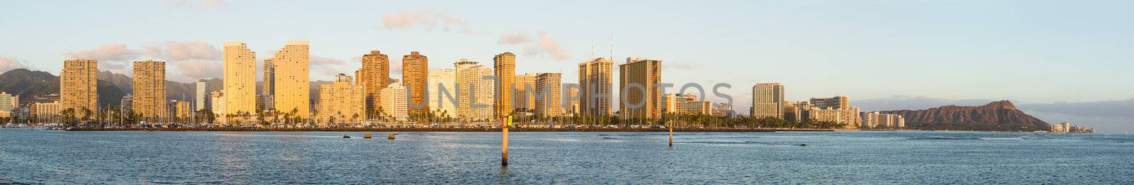 Sunset view of panorama of Waikiki Oahu Hawaii from city to Diamond head crater with hotels and apartment condo buildings