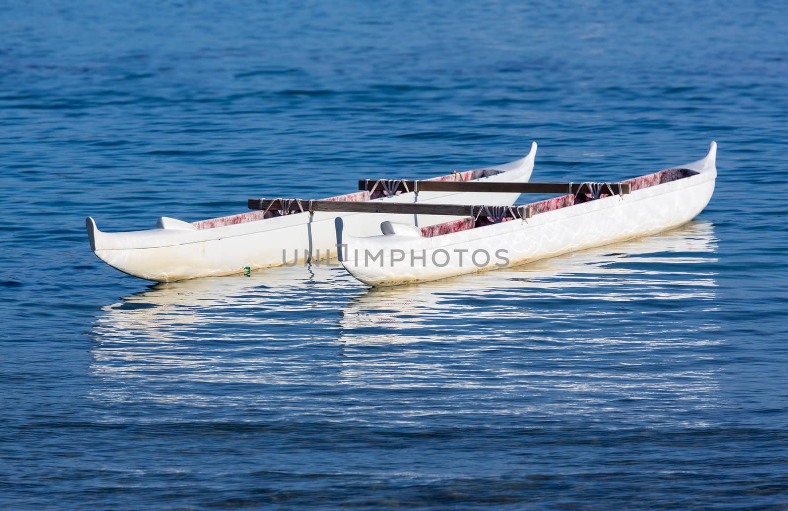 Canoe floating in blue ocean in Waikiki Beach area of Oahu in Hawaii