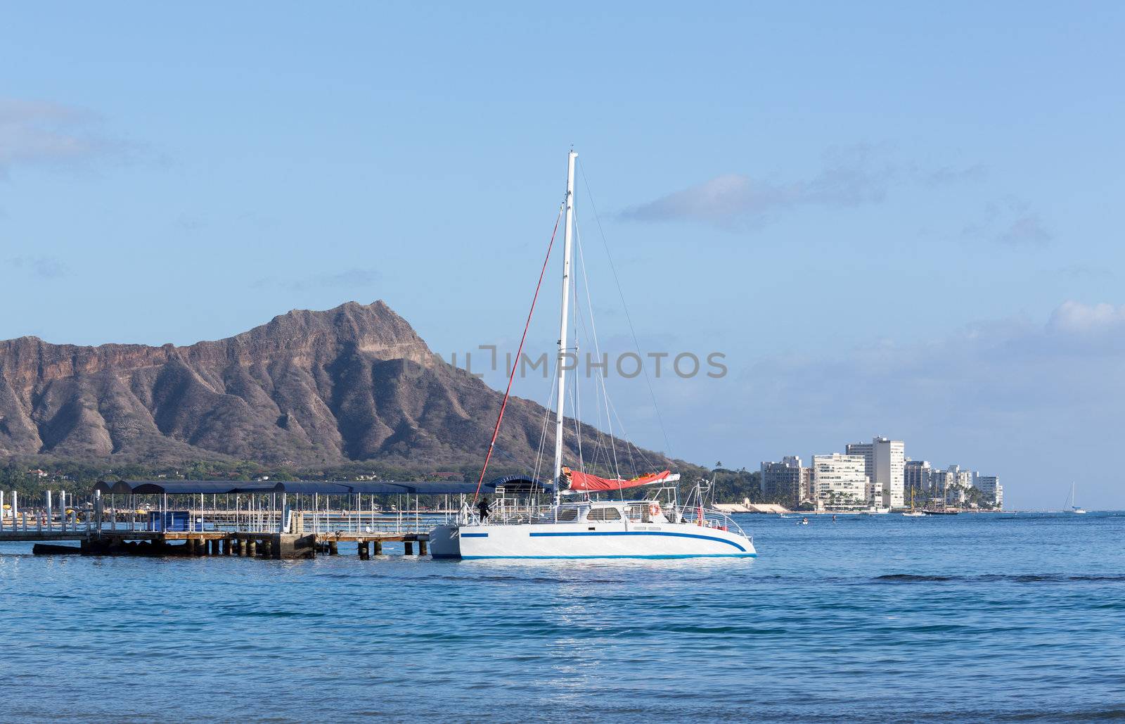 Boat docked in front of Diamond Head and Waikiki Beach area of Oahu in Hawaii