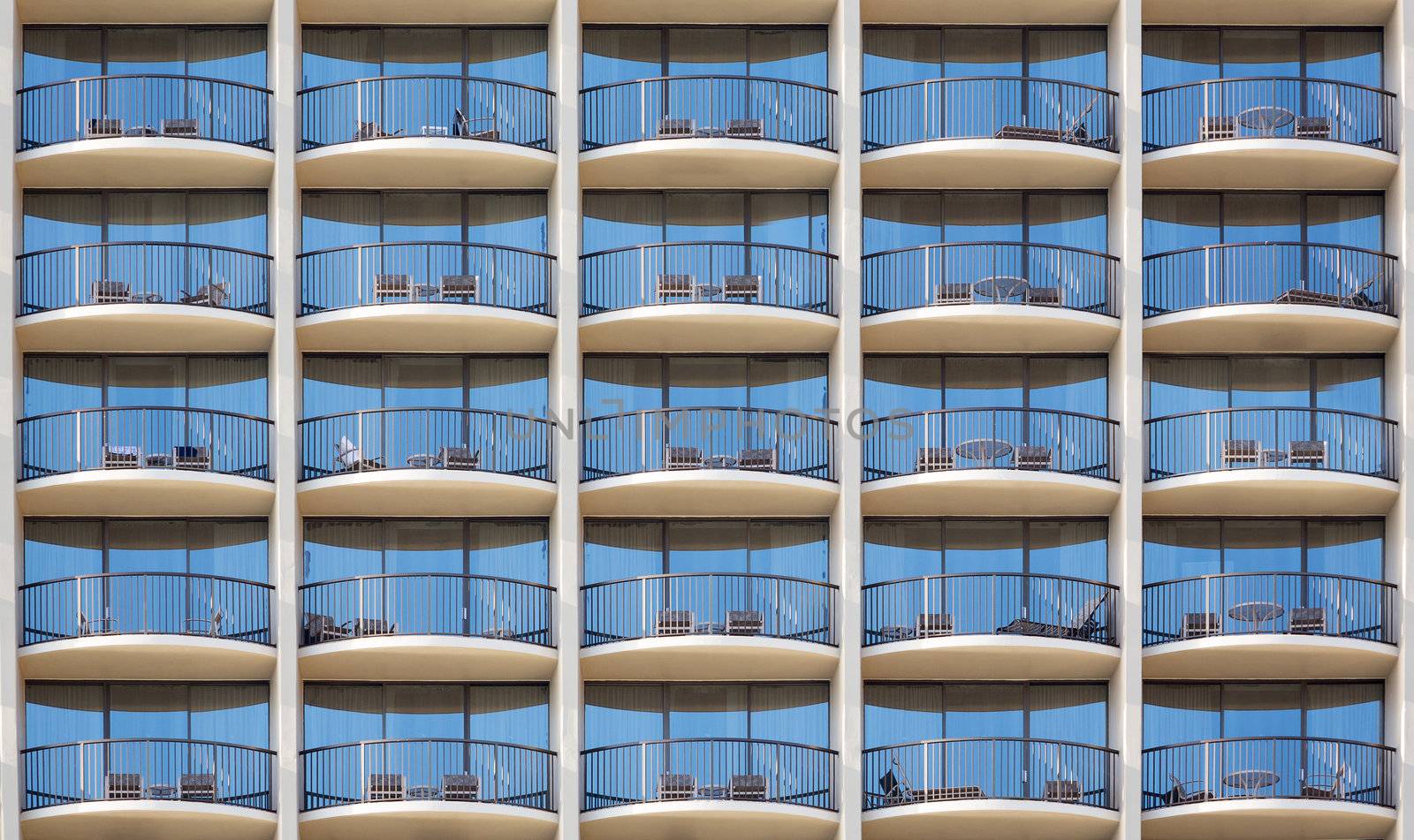 Pattern of hotel room balconies in modern building with all door closed and regular