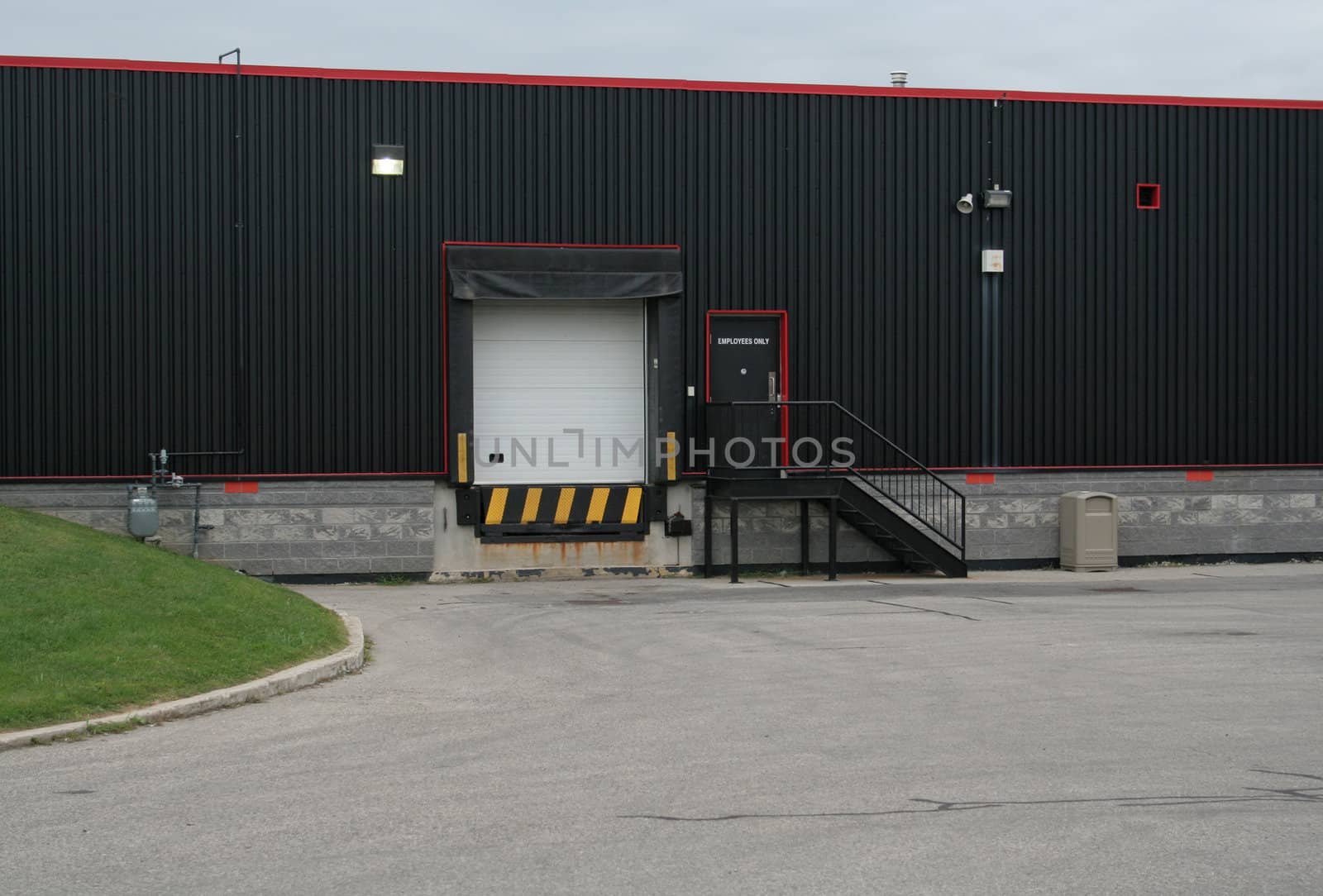 The exterior loading dock of an industrial warehouse.
