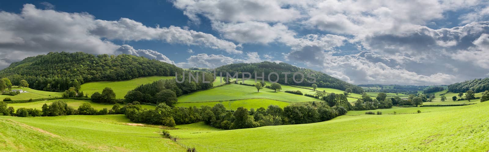 Broad panorama of the countryside in North Wales with green field in foreground