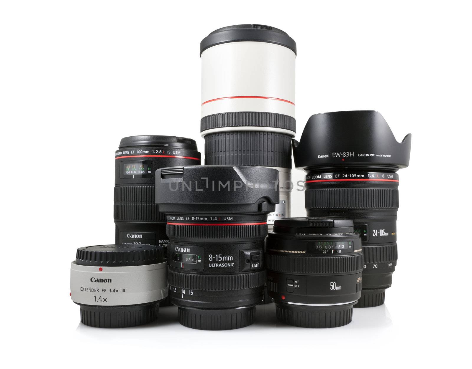 A studio shot on a white background of a collection of Canon lenses including the EF 300mm f/4L IS USM, EF 24-105 f/4L IS USM, EF 100mm f/2.8L Macro IS USM, EF 50mm f/1.4 USM, EF 8-15mm f/4L Fisheye USM, and EF 1.4X III extender.
