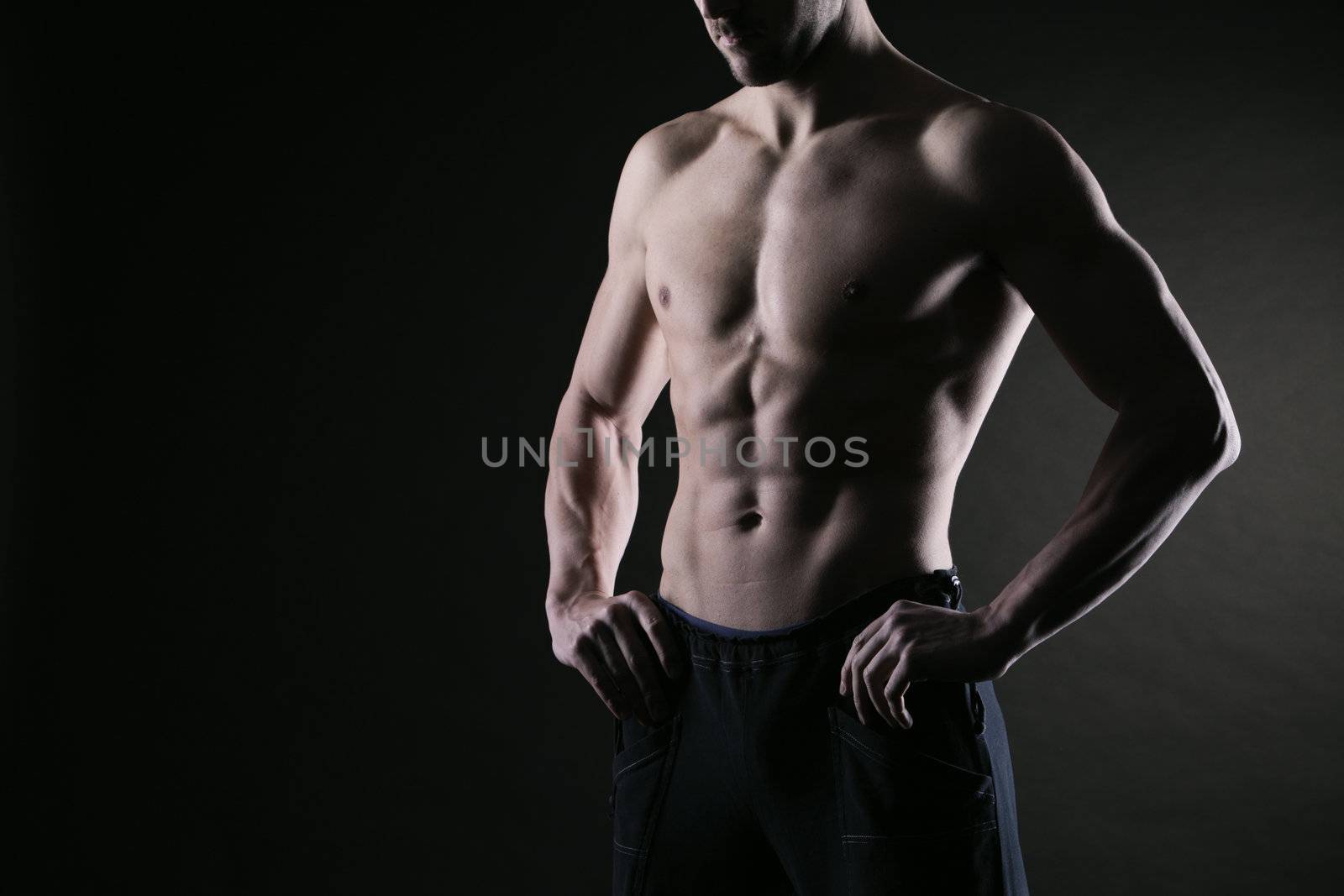 Sexy muscular man on dark background