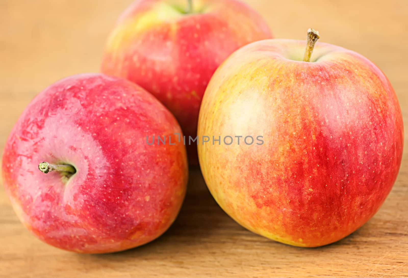 red apples on a  old wooden surface