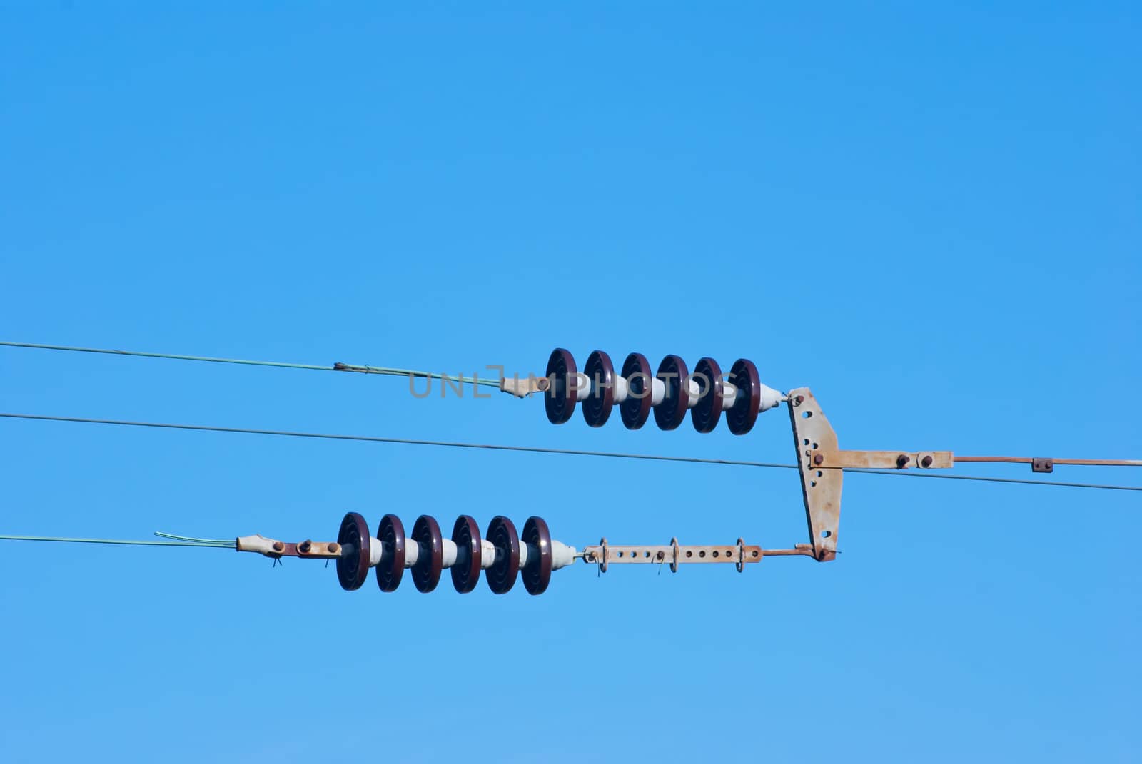 Railroad wire pole against clear blue sky