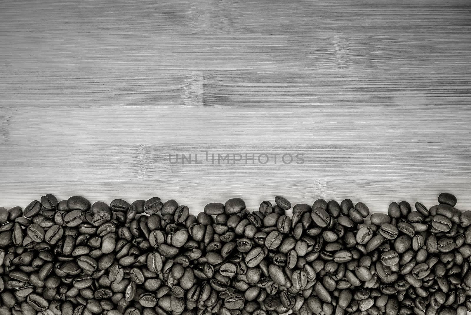 A pile of coffee beans forming a simple stripe frame on a natural background,  black and white photo