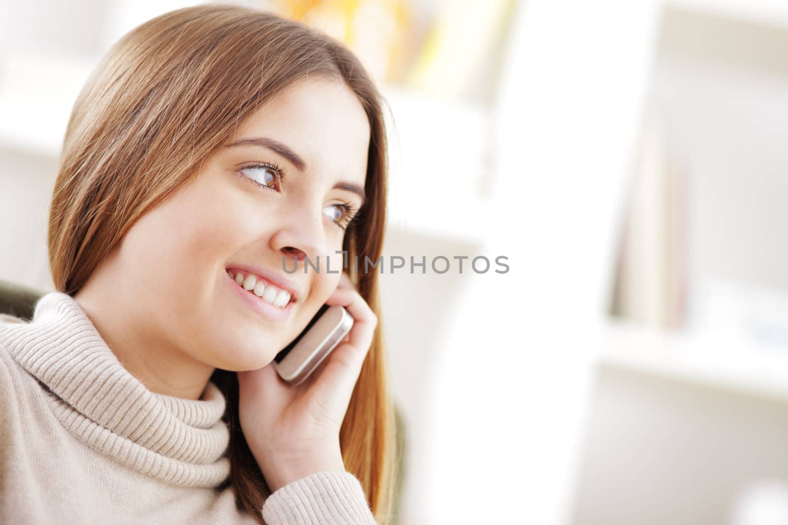 Beautiful young woman talking on cell phone