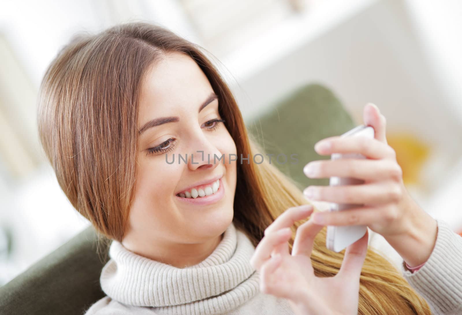 Young beautiful woman text messaging