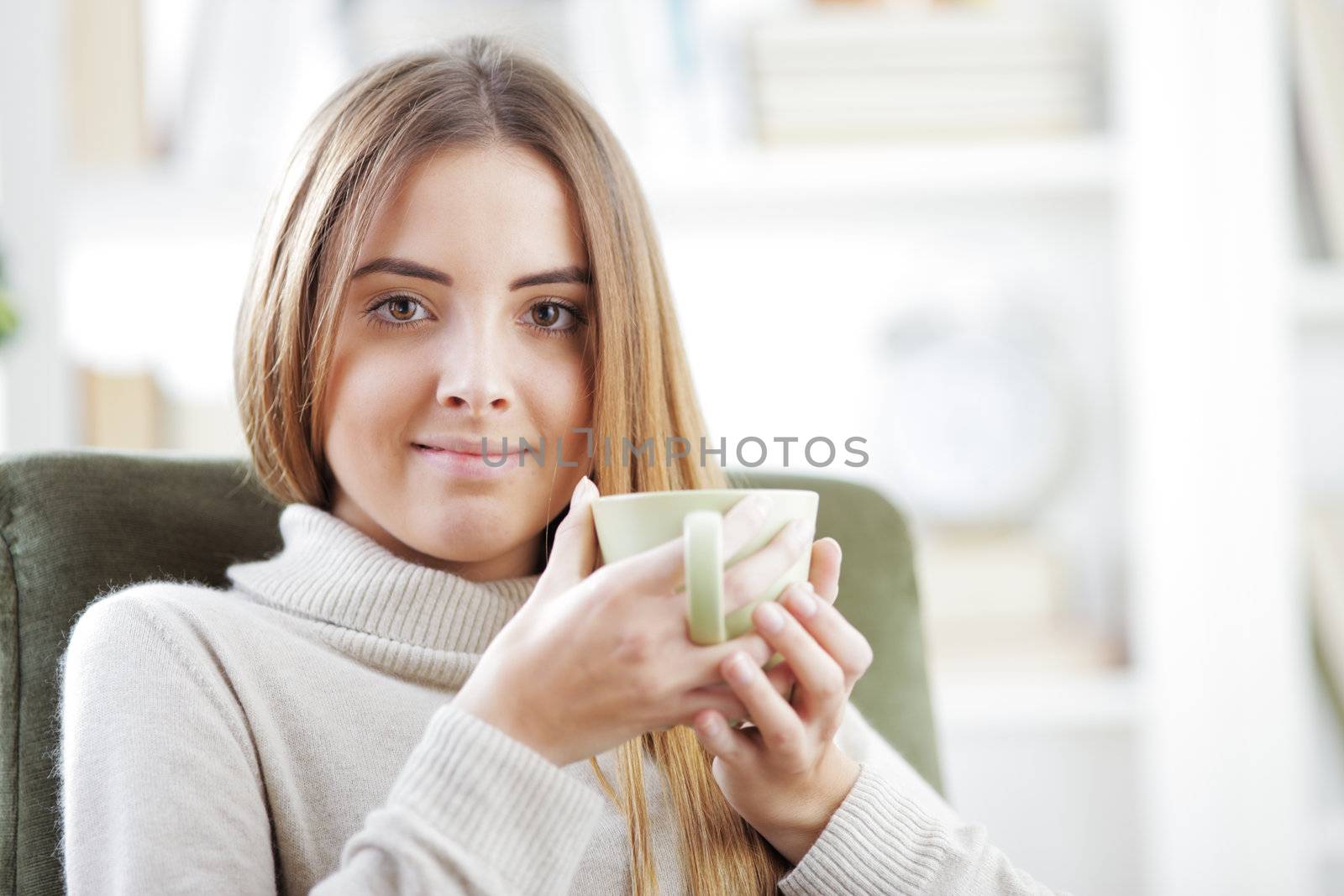 Beautiful young woman with a cup of coffee or tea