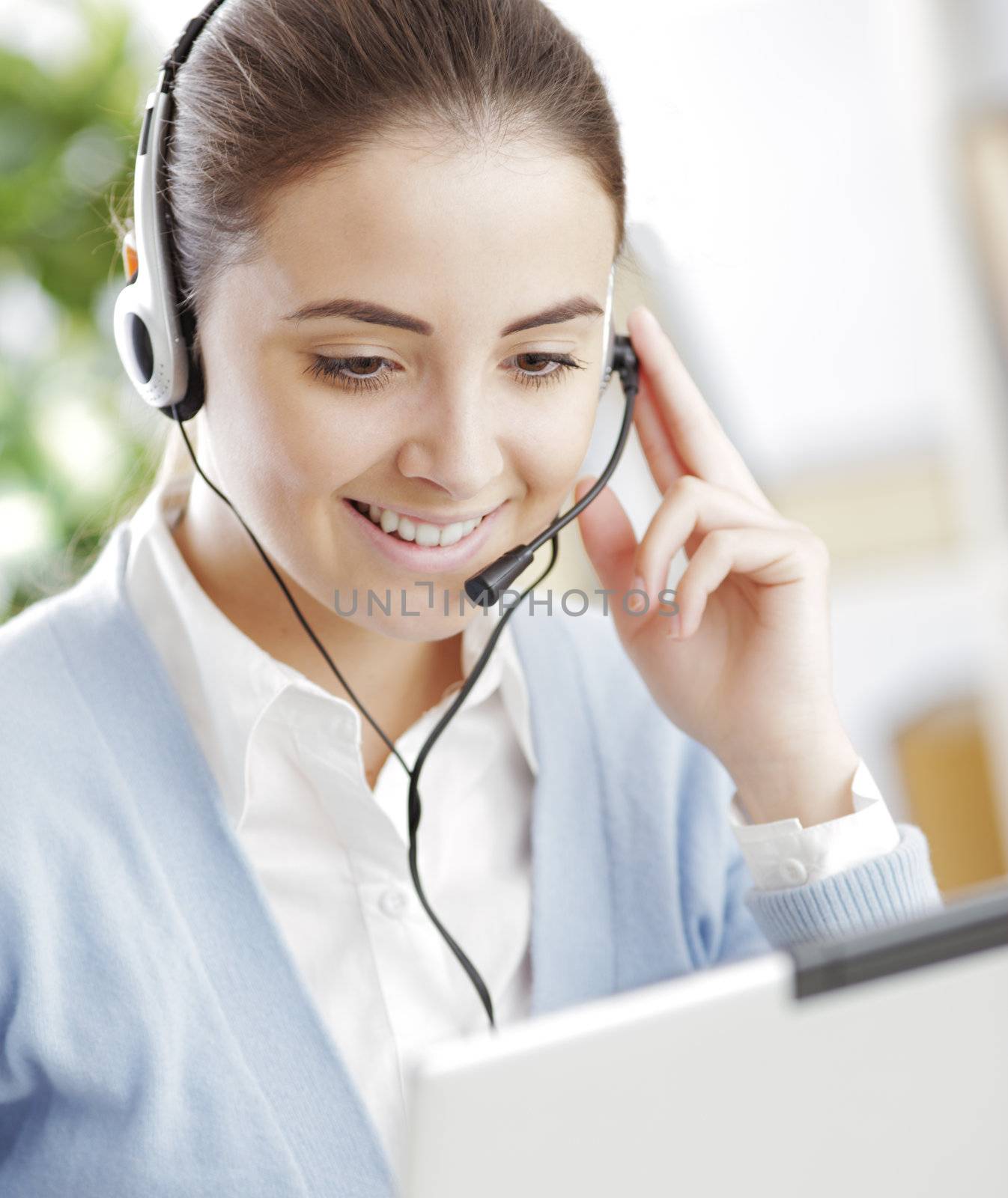 Young girl chating on laptop with headset