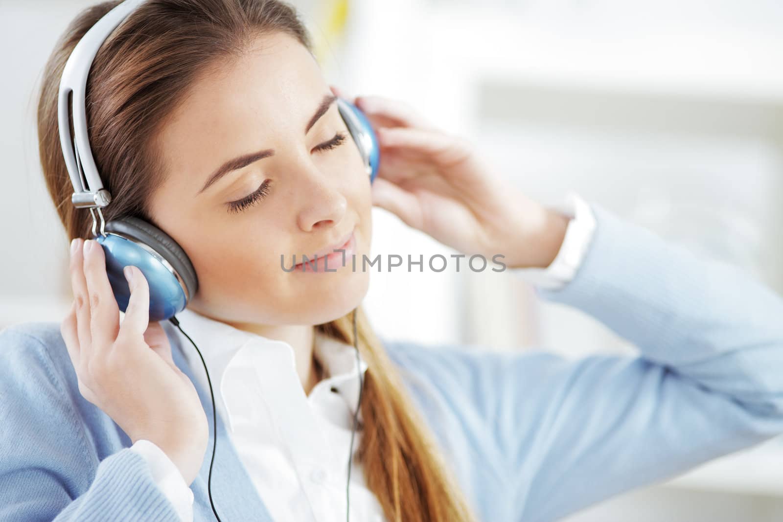 Woman wearing headphones, listening to music