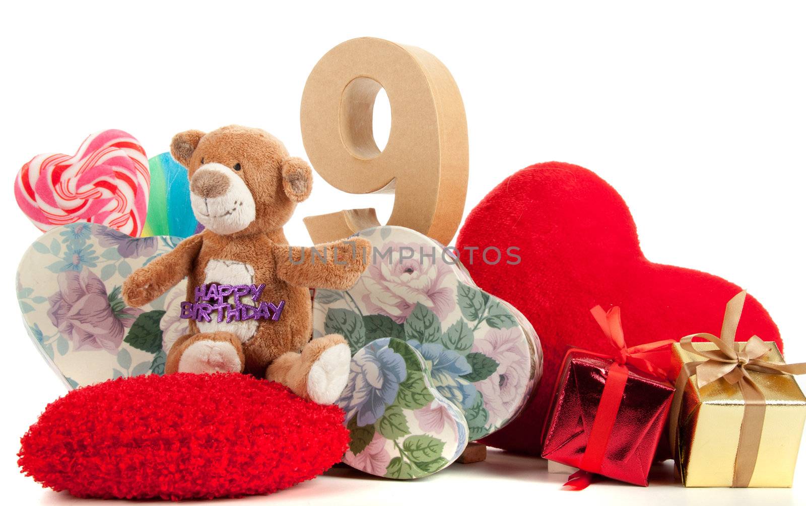 Number of age in a colorful studio setting with heart and gifts and yellow roses