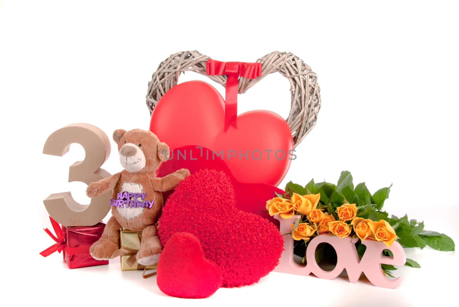 Number of age in a colorful studio setting with heart and gifts and yellow roses
