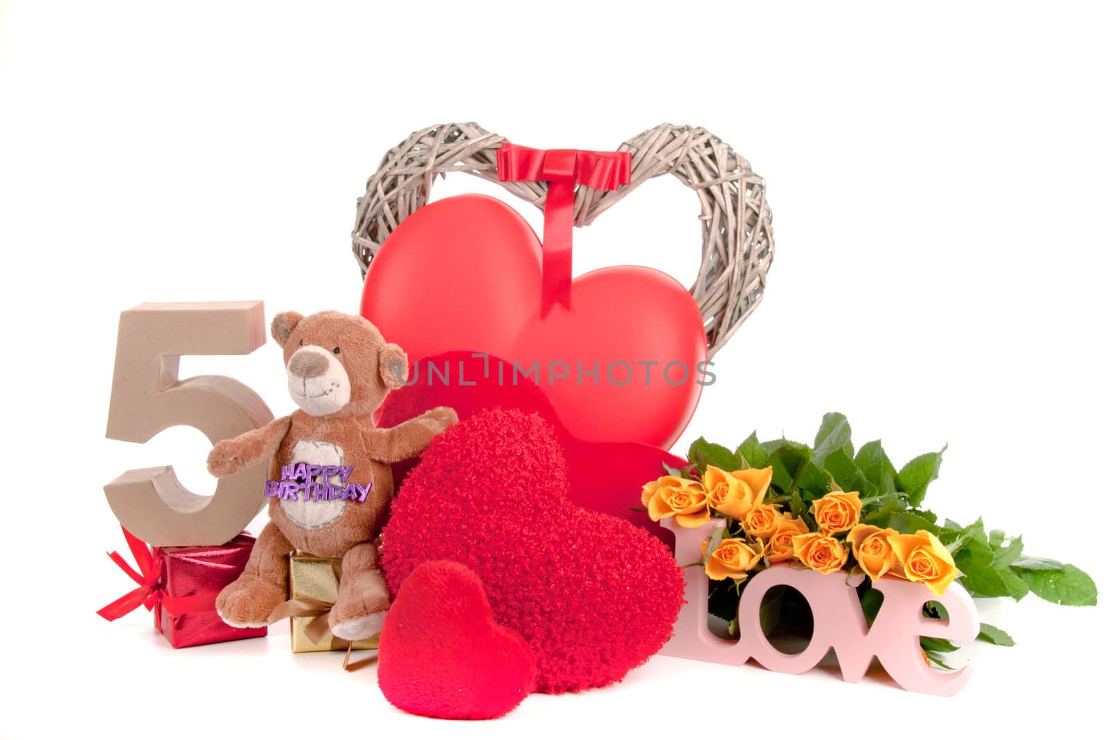 Number of age in a colorful studio setting with heart and gifts and yellow roses