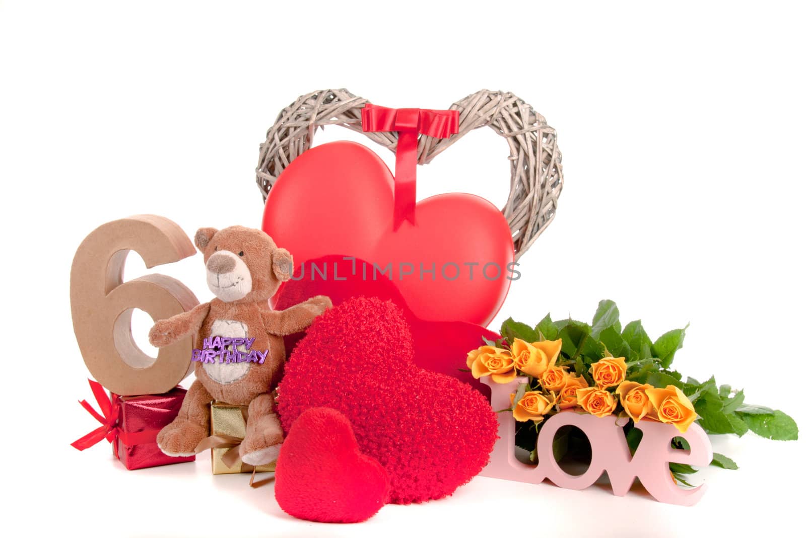 Number of age in a colorful studio setting with heart and gifts and yellow roses