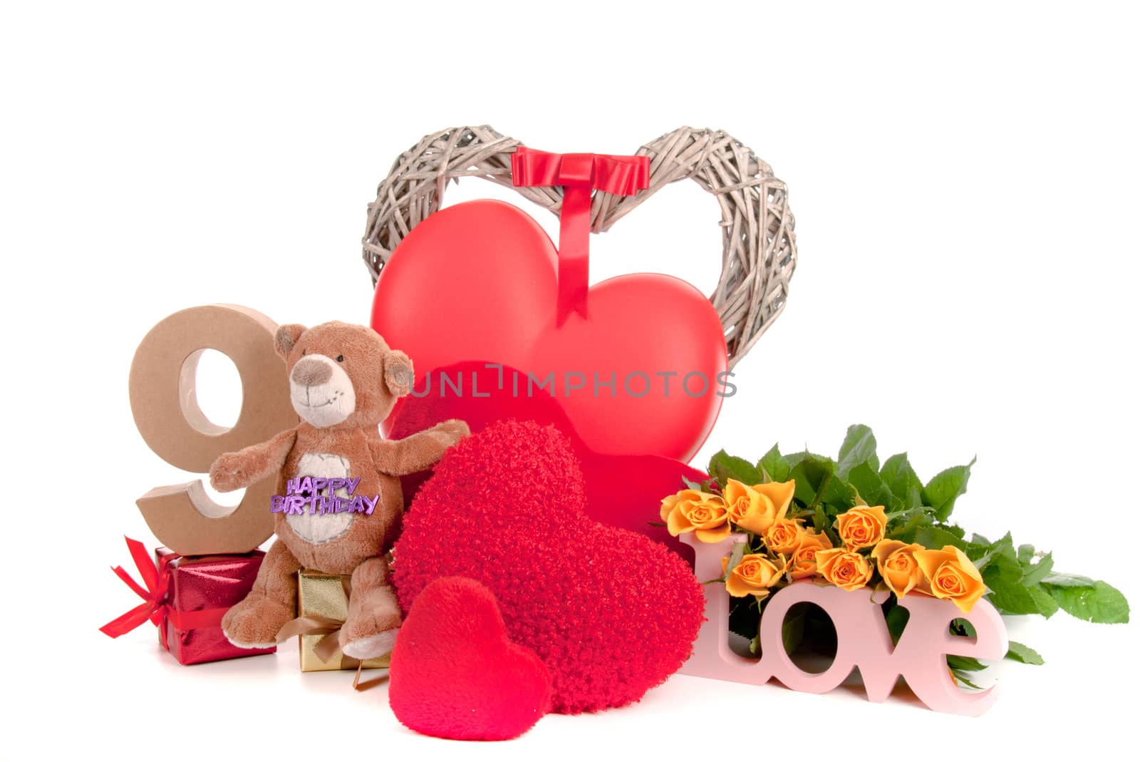 Number of age in a colorful studio setting with heart and gifts and yellow roses