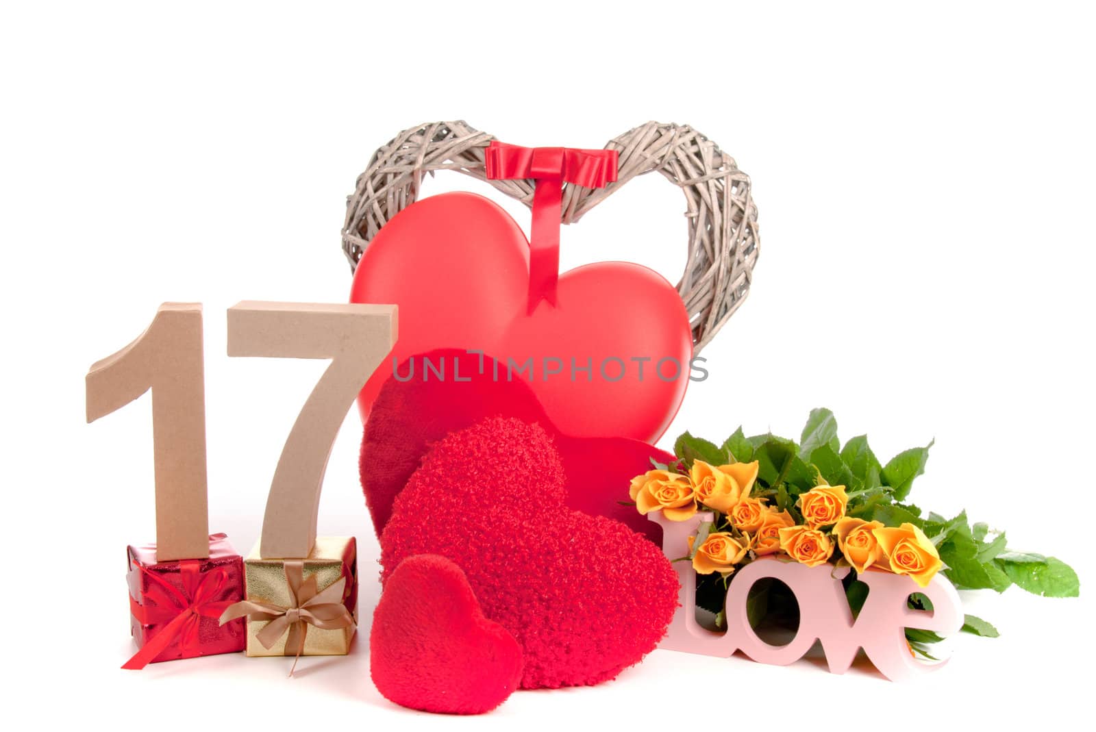 Number of age in a colorful studio setting with heart and gifts and yellow roses