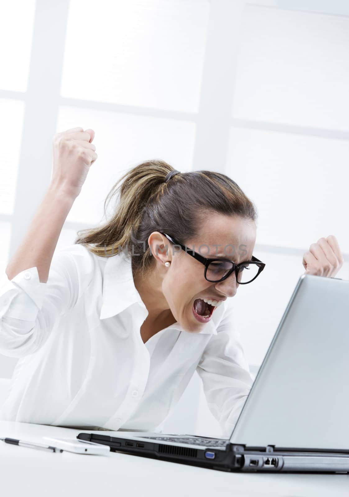 Freaked out businesswoman ready to smash her laptop computer 