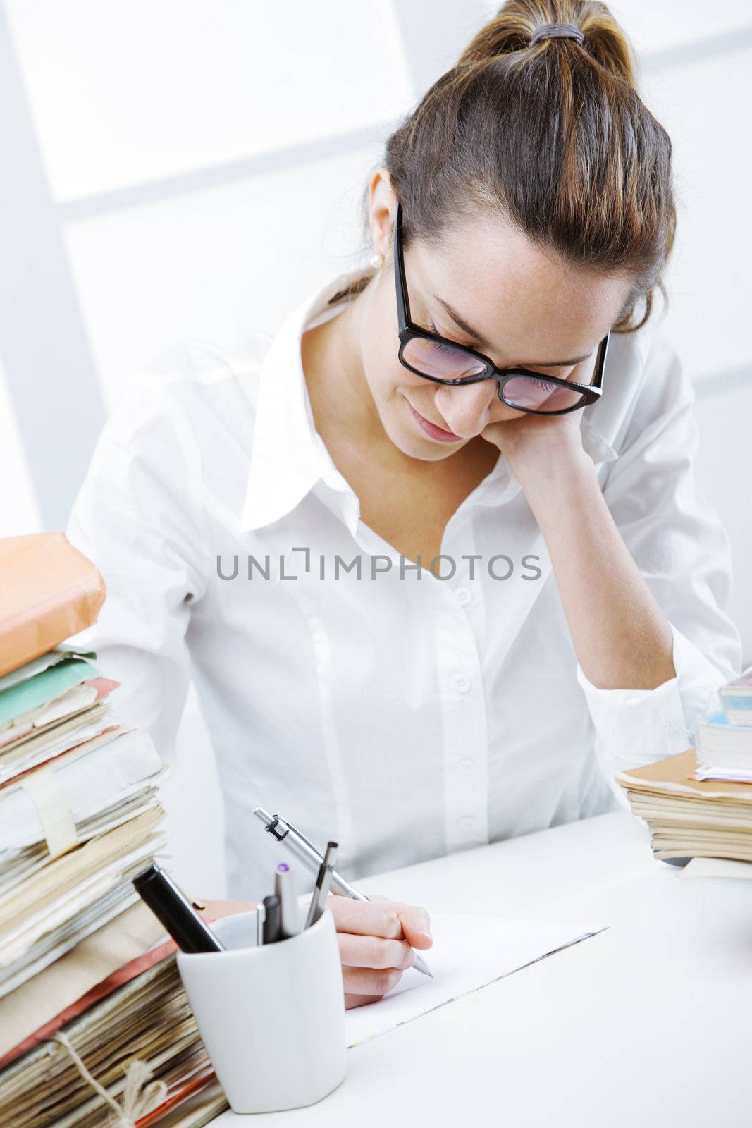 Business woman taking notes in office