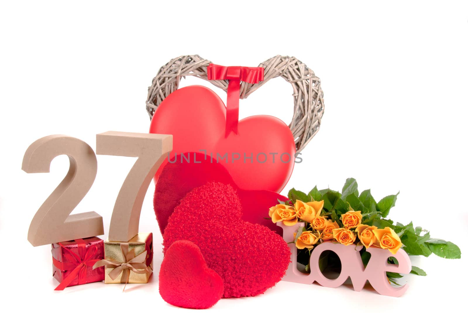 Number of age in a colorful studio setting with heart and gifts and yellow roses
