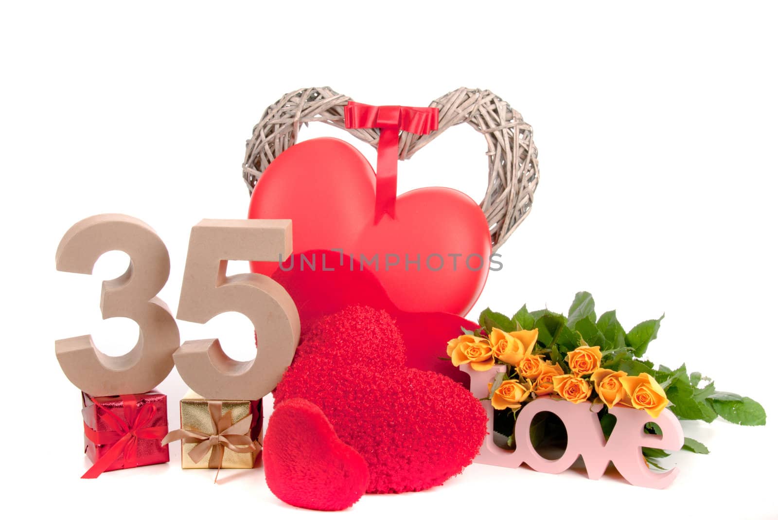 Number of age in a colorful studio setting with heart and gifts and yellow roses