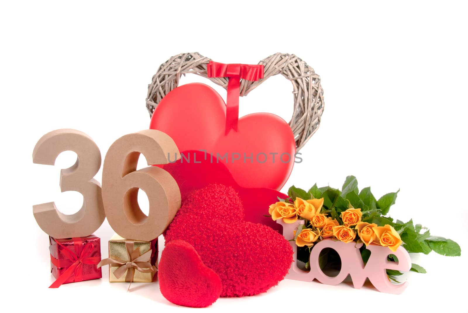 Number of age in a colorful studio setting with heart and gifts and yellow roses