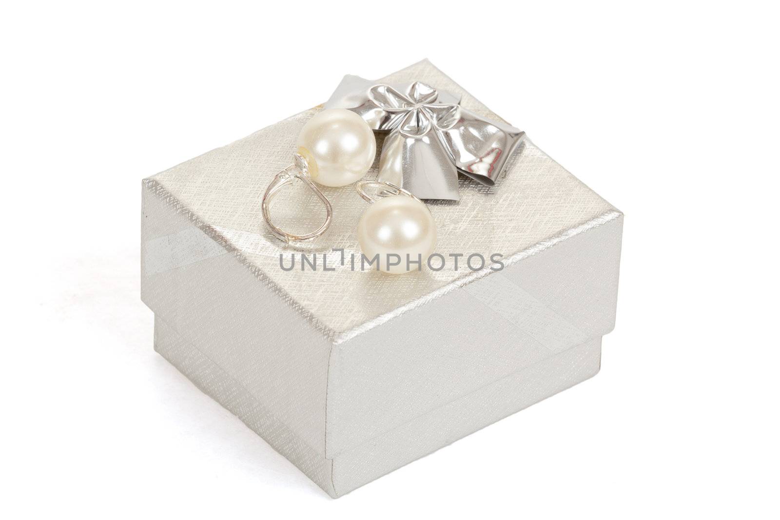 two pearl earrings and gift box isolated on white background