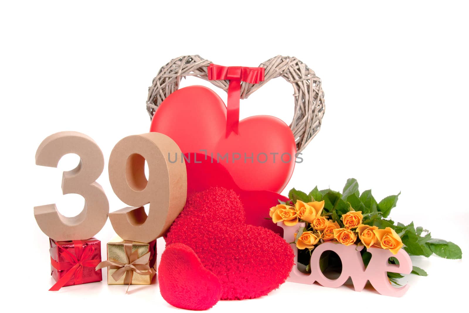 Number of age in a colorful studio setting with heart and gifts and yellow roses