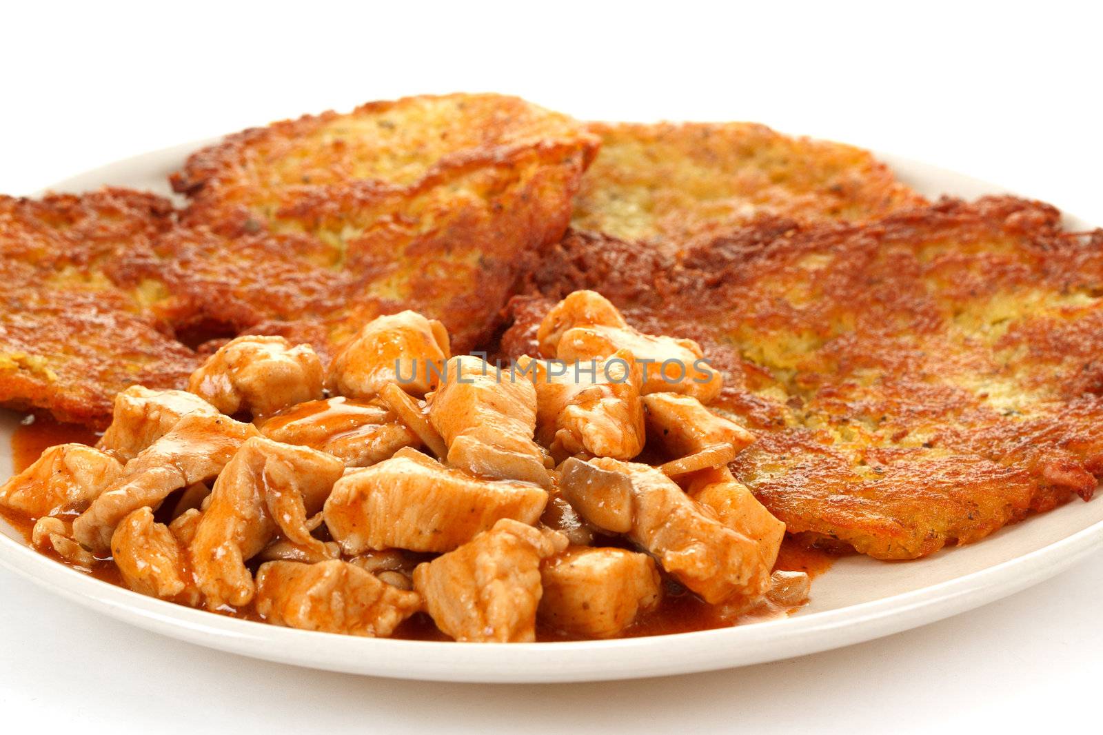 Potato pancakes with chicken meat on white background