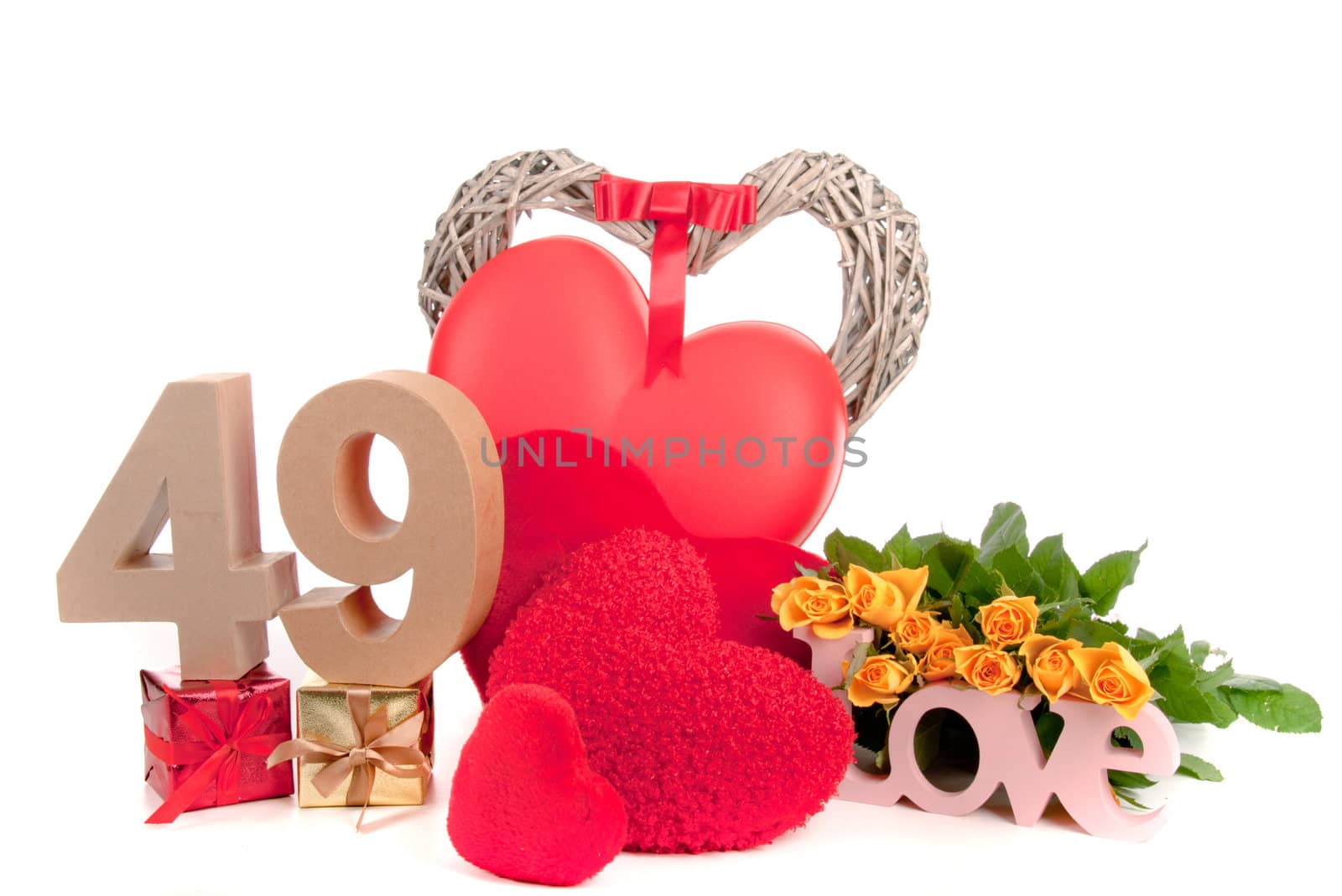 Number of age in a colorful studio setting with heart and gifts and yellow roses