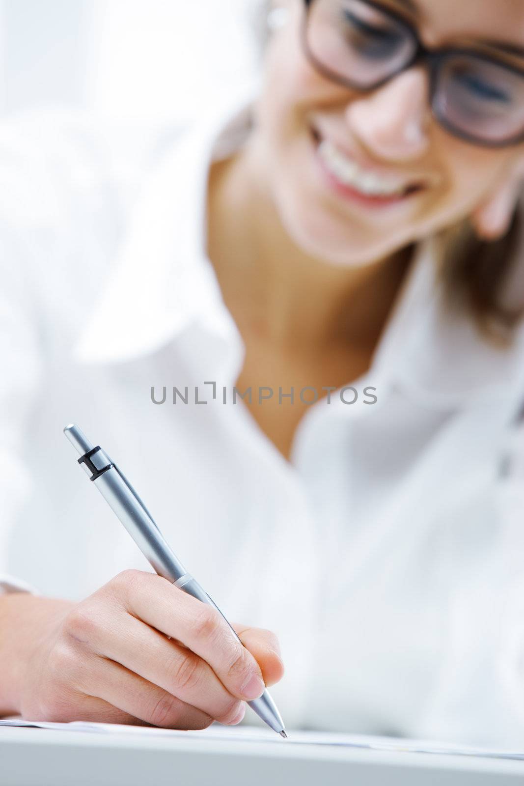 Business woman writing on a document, hand close up