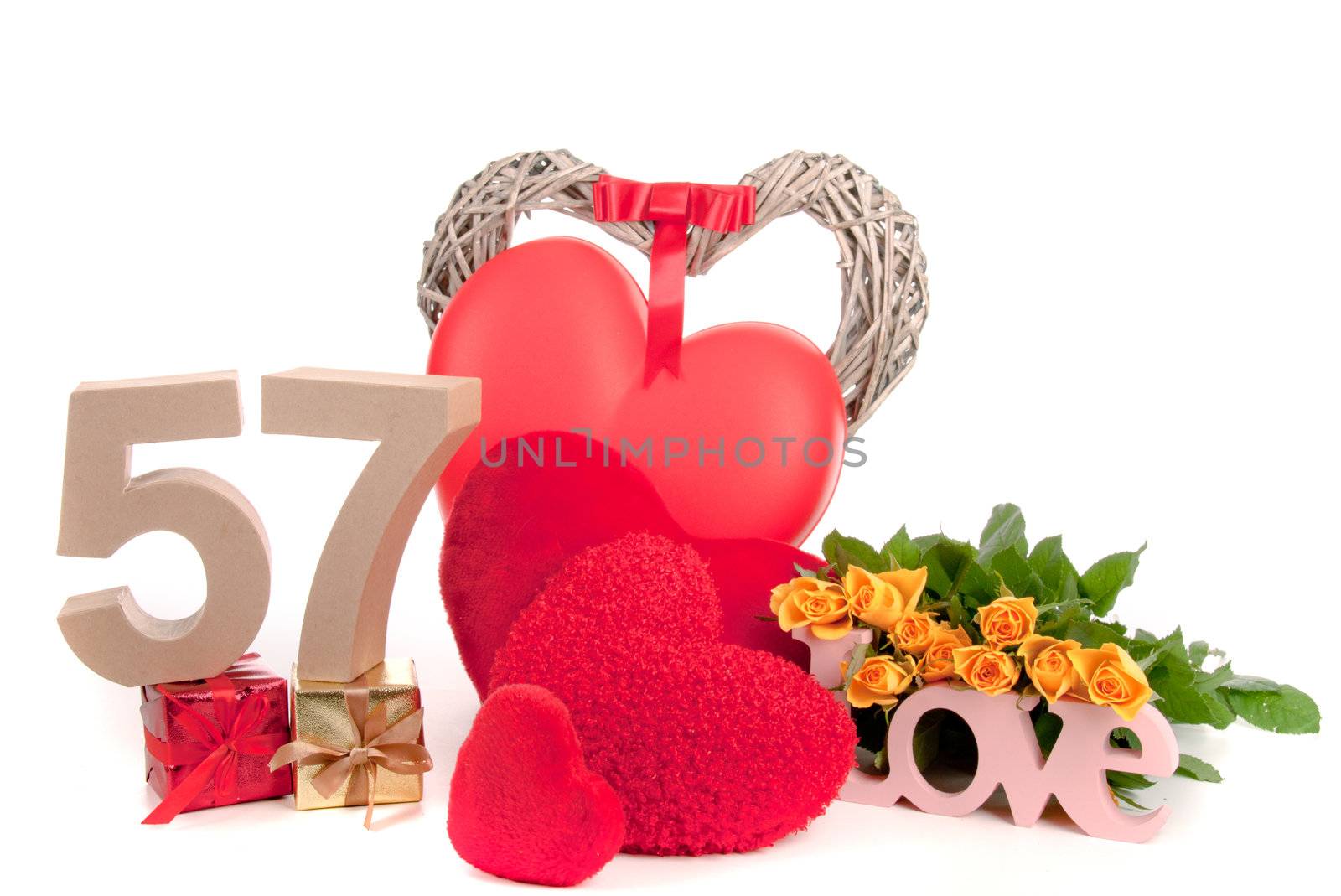 Number of age in a colorful studio setting with heart and gifts and yellow roses