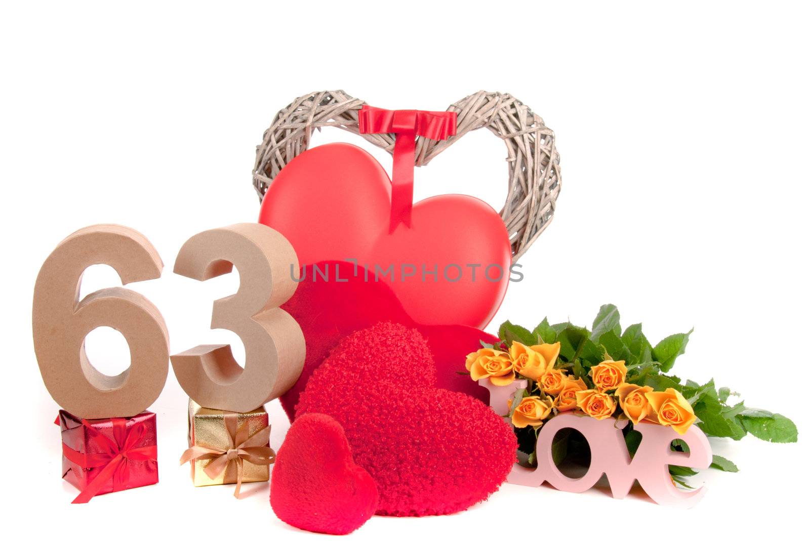 Number of age in a colorful studio setting with heart and gifts and yellow roses