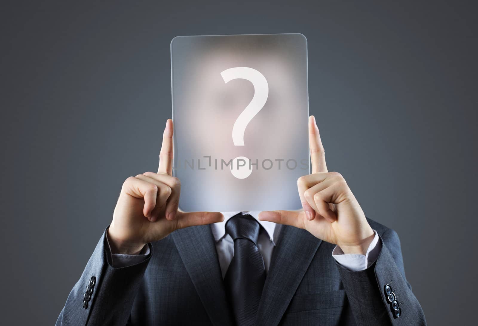 Young business man holding question mark signs in front of his faces