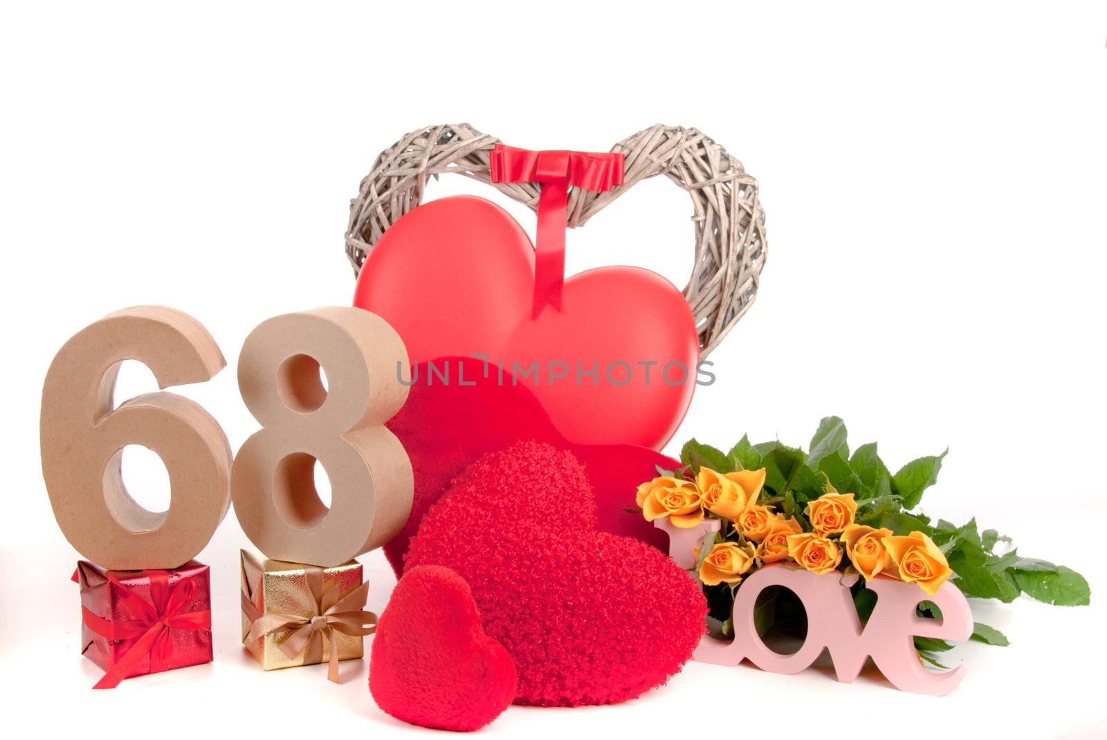 Number of age in a colorful studio setting with heart and gifts and yellow roses