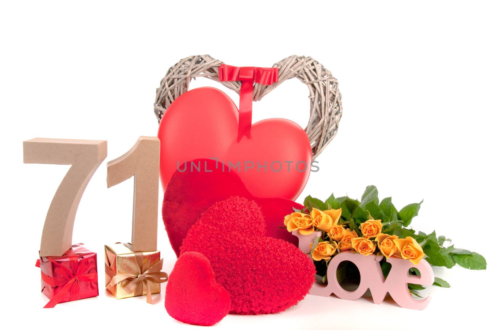 Number of age in a colorful studio setting with heart and gifts and yellow roses