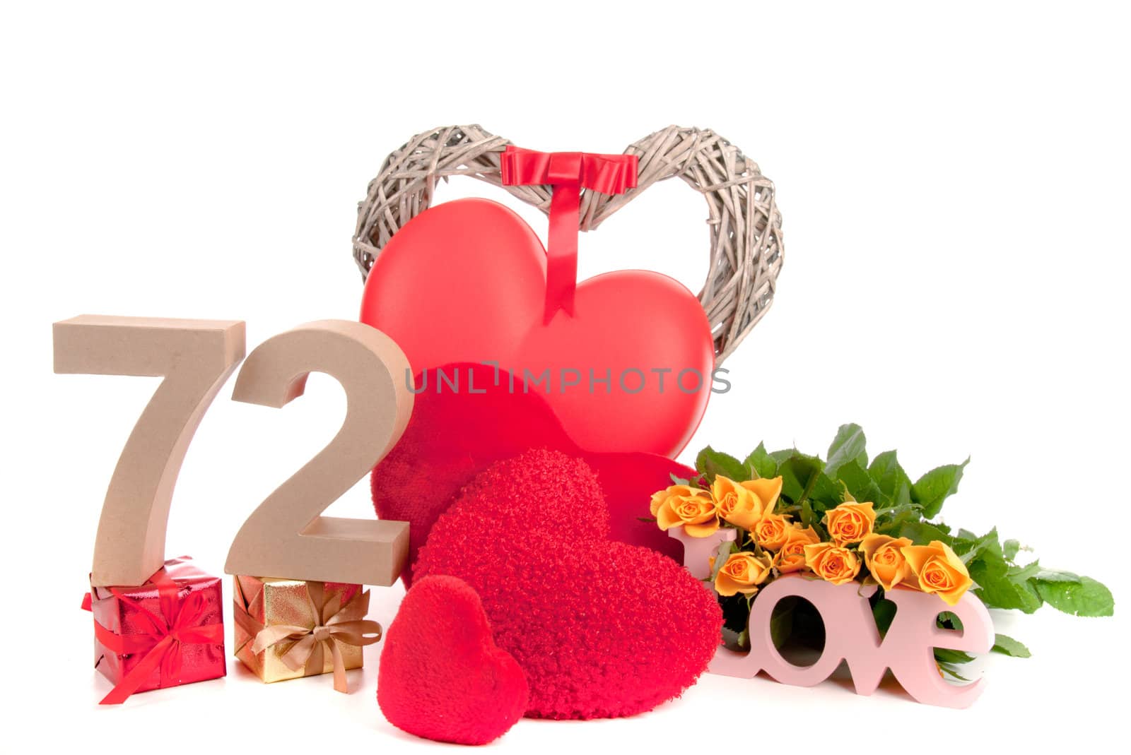 Number of age in a colorful studio setting with heart and gifts and yellow roses
