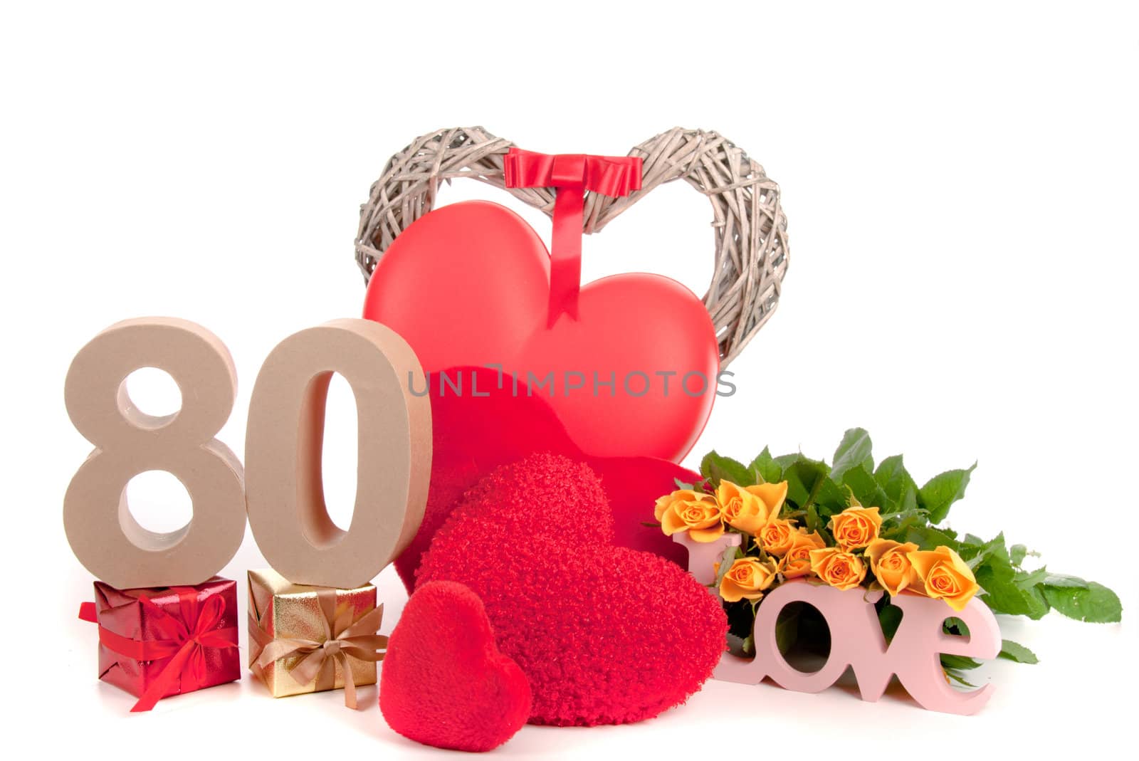 Number of age in a colorful studio setting with heart and gifts and yellow roses