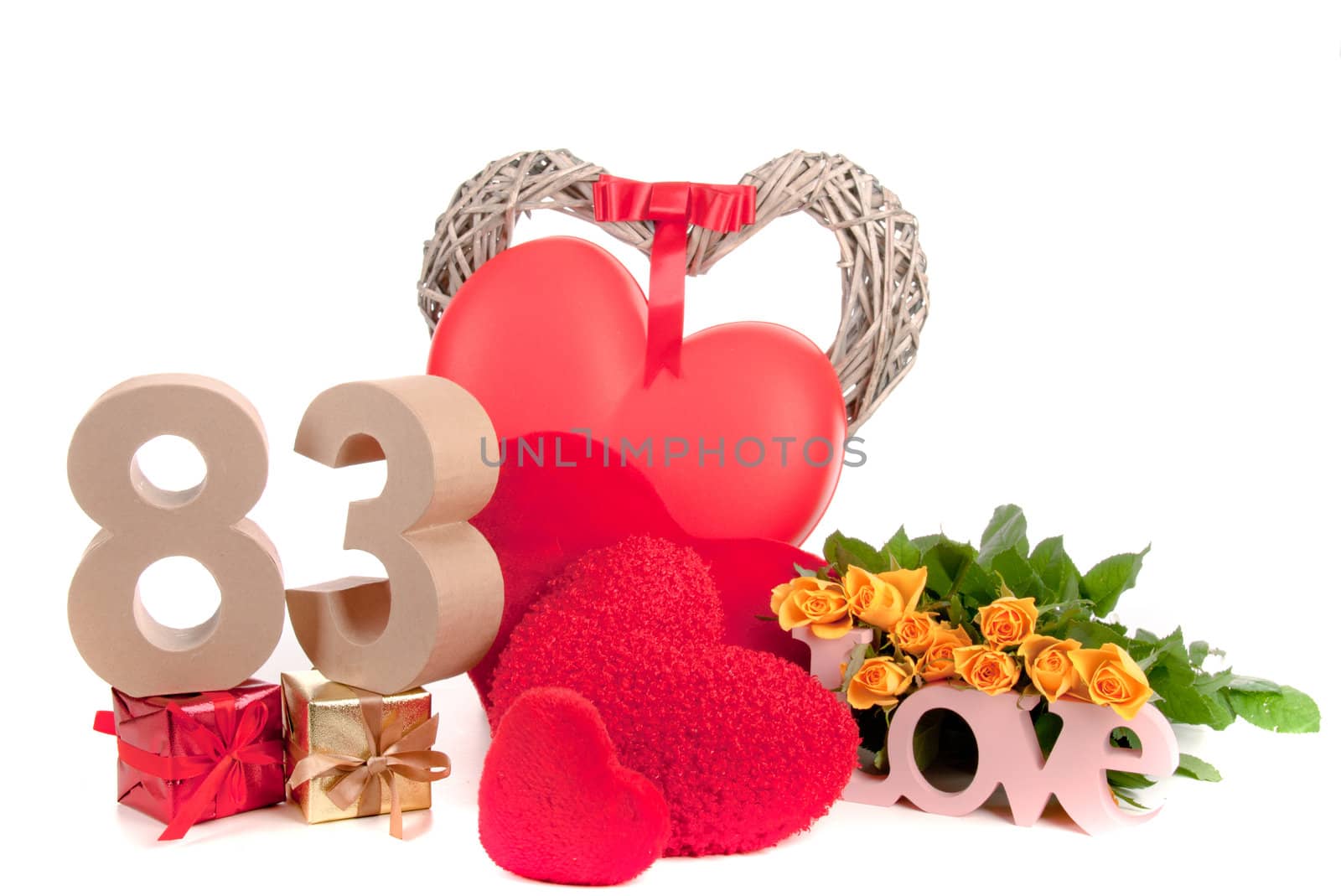 Number of age in a colorful studio setting with heart and gifts and yellow roses