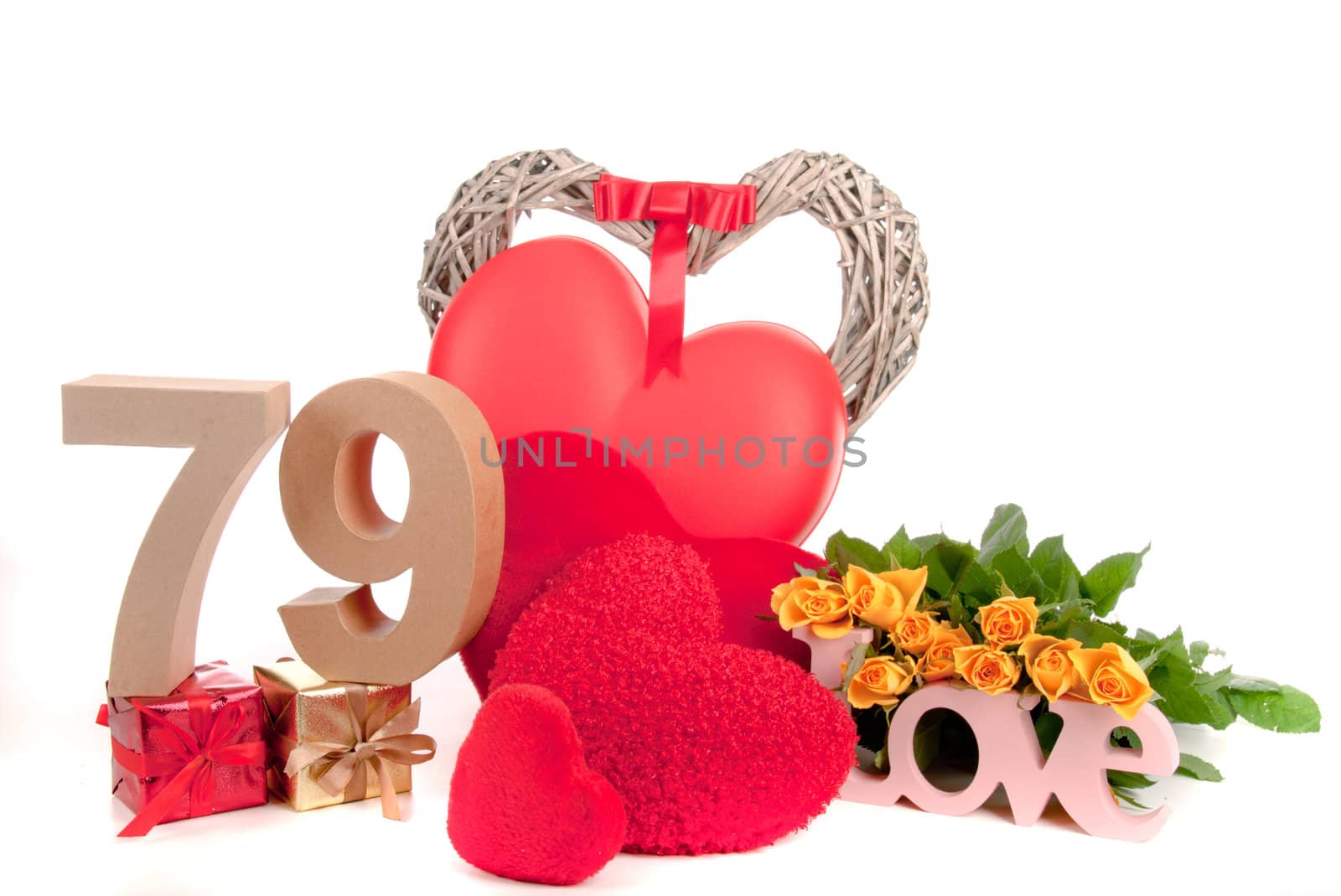 Number of age in a colorful studio setting with heart and gifts and yellow roses