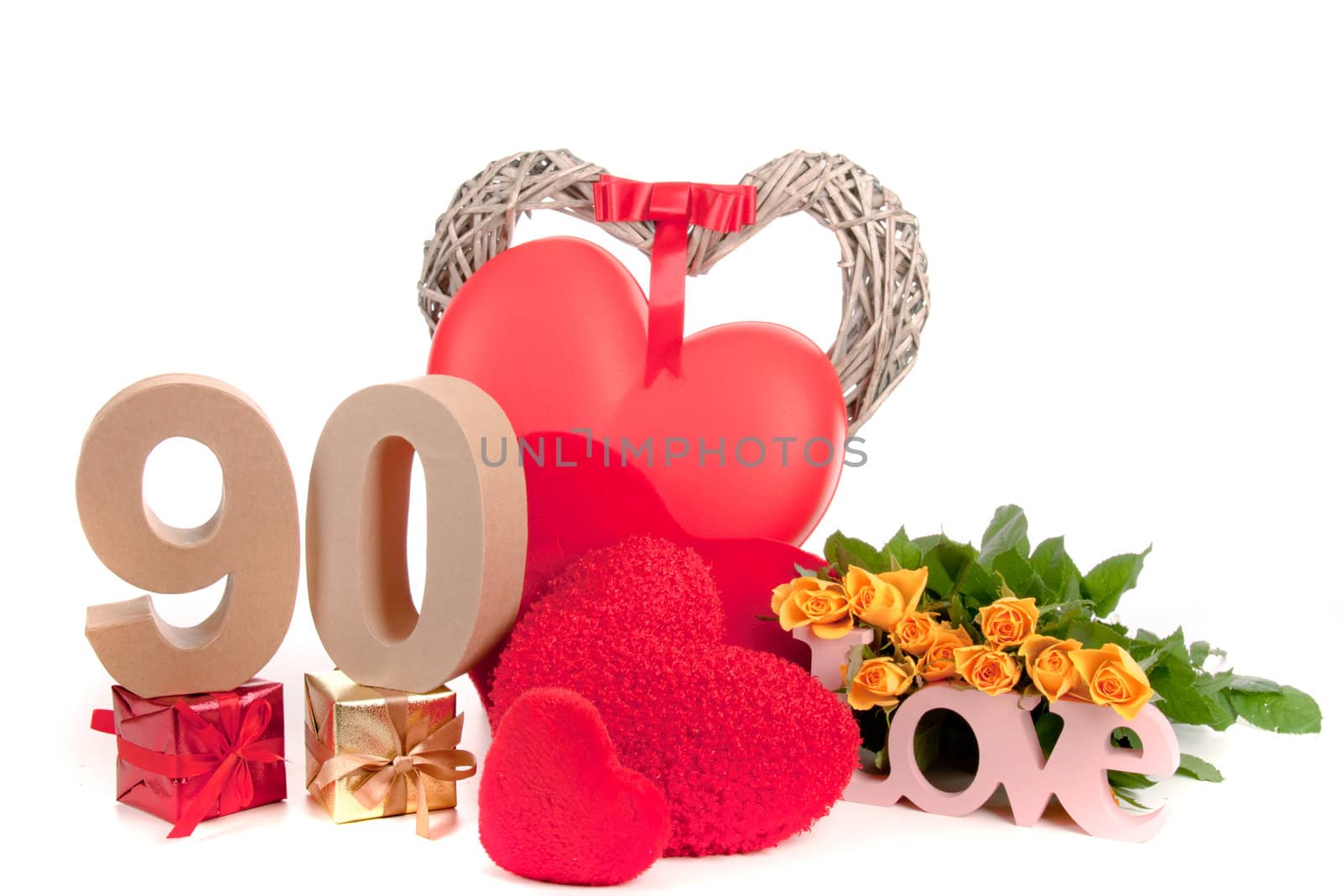 Number of age in a colorful studio setting with heart and gifts and yellow roses