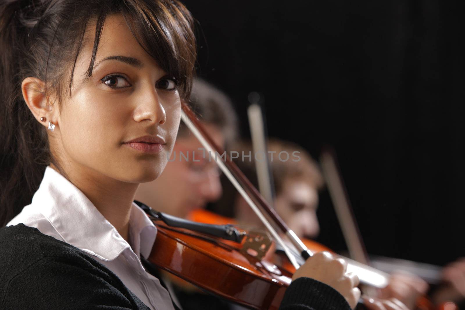 Classical music concert: Portrait of young woman violinist by stokkete