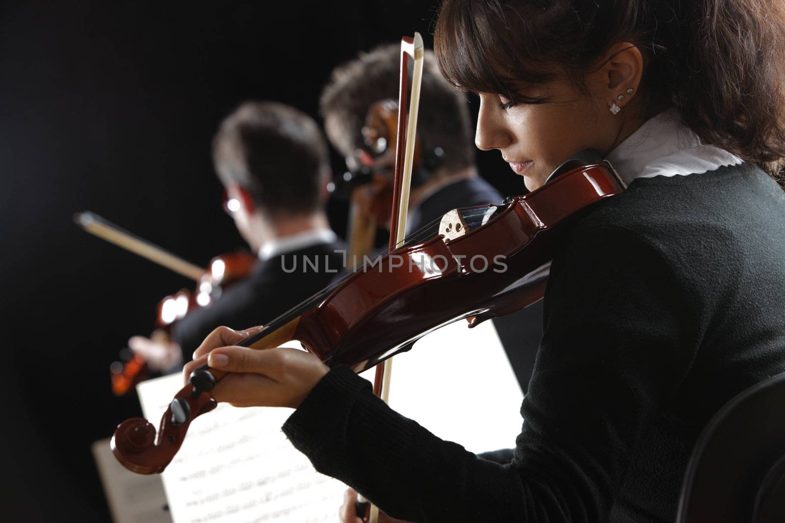 Violinist woman playing a concert of classical music
