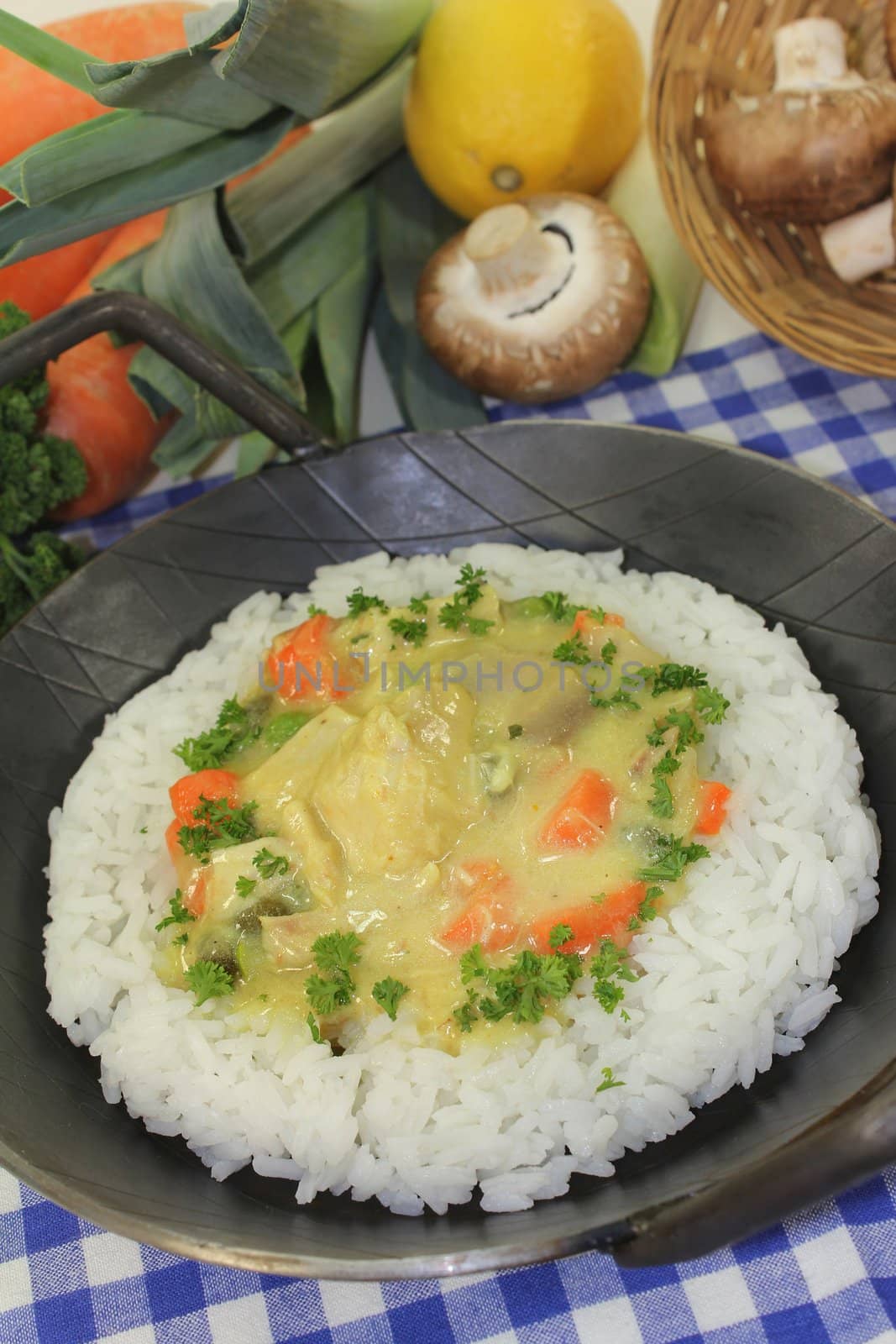 a pan with rice and colorful chicken fricassee