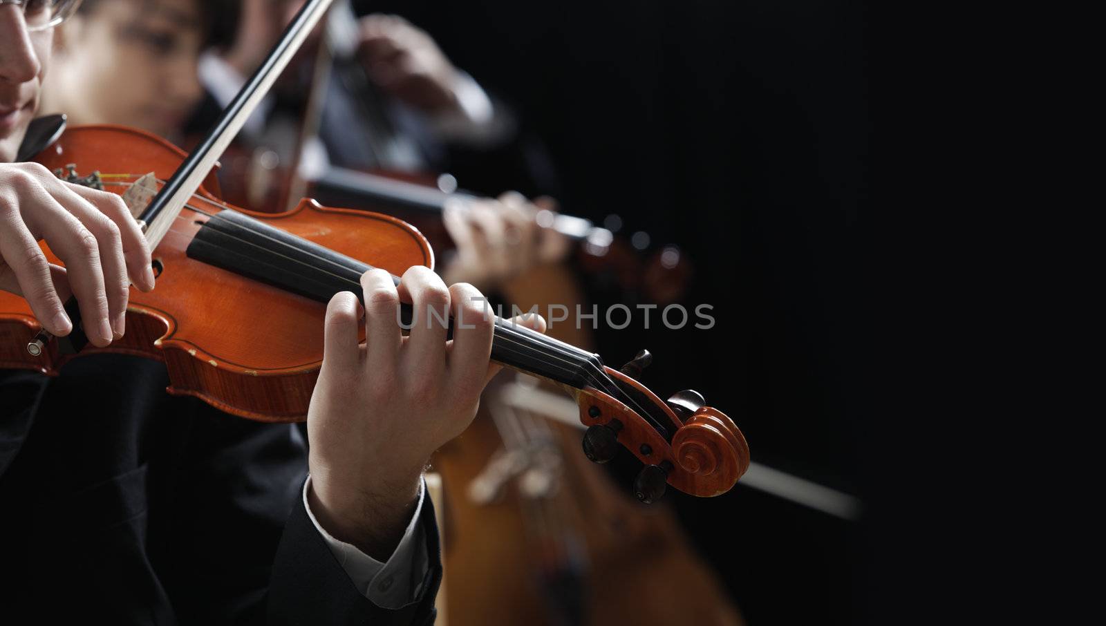 Symphony music, violinist at concert, hand close up