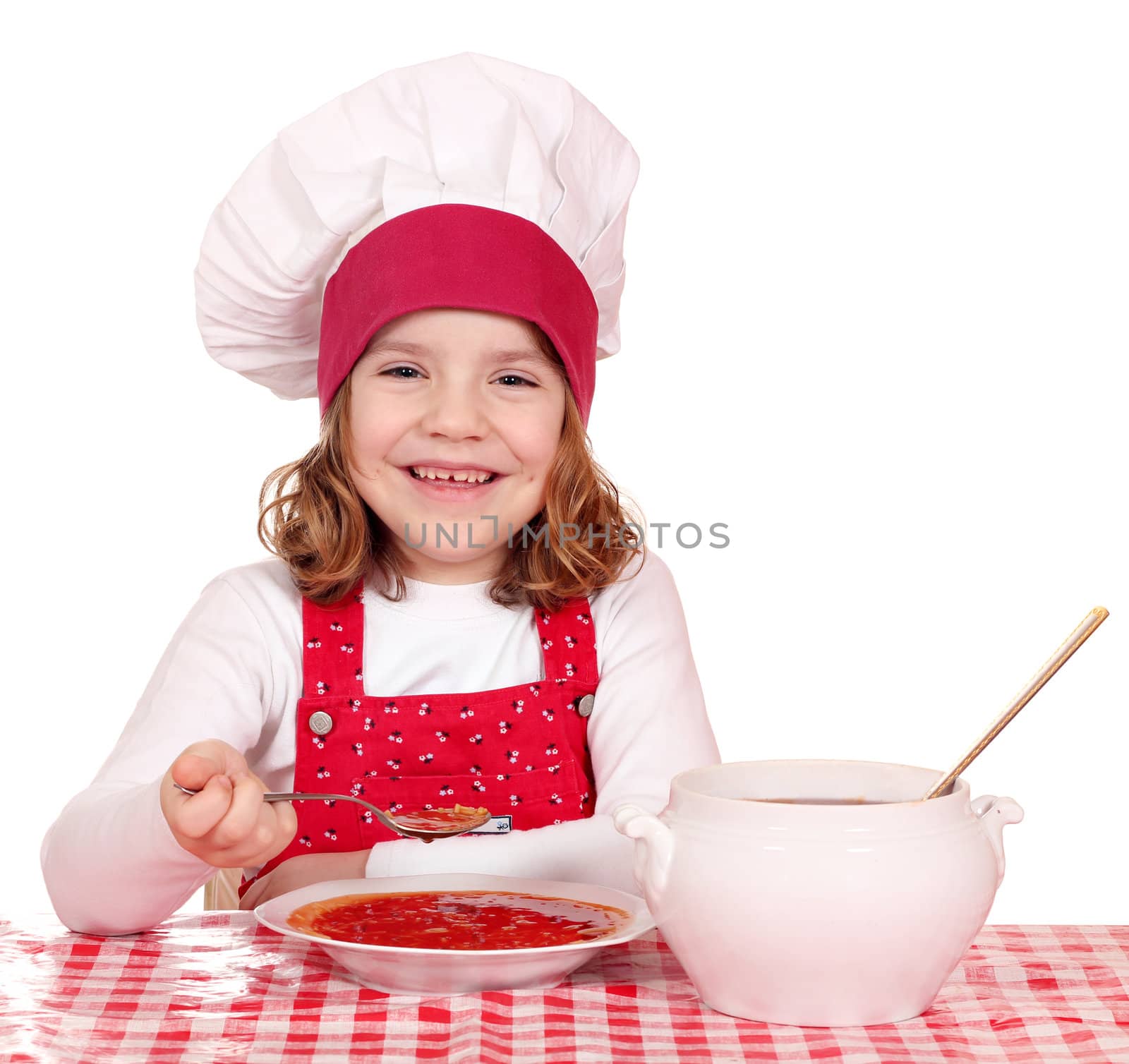 happy little girl cook eating soup
