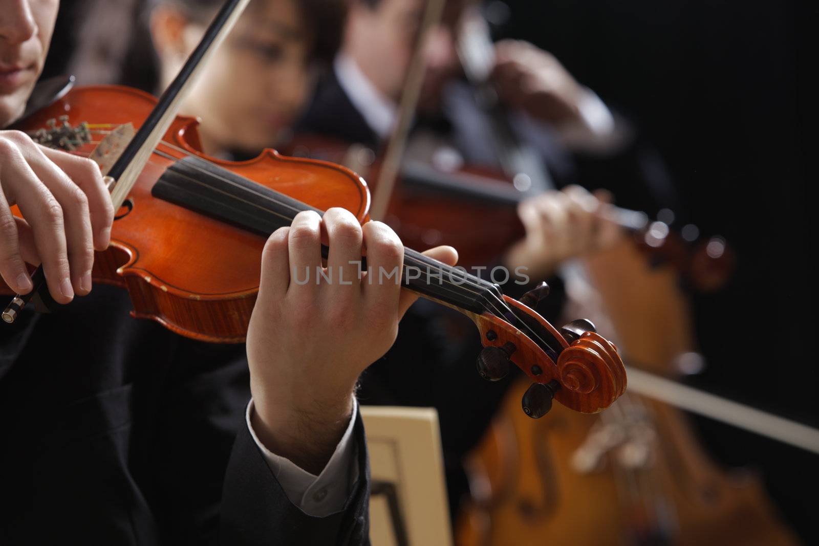 Symphony music, violinist at concert, hand close up